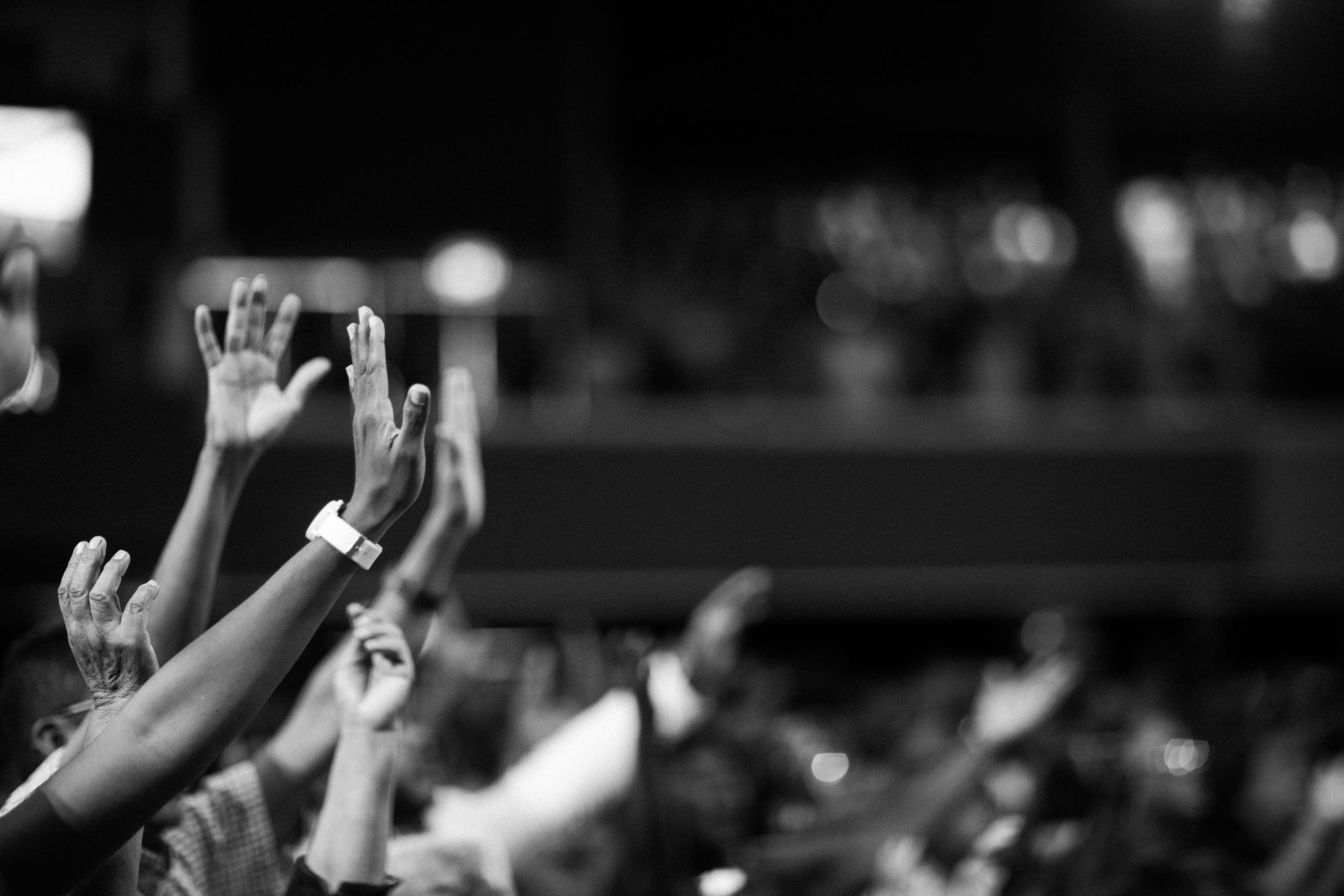 grayscale-photography-of-hands-waving-2014773